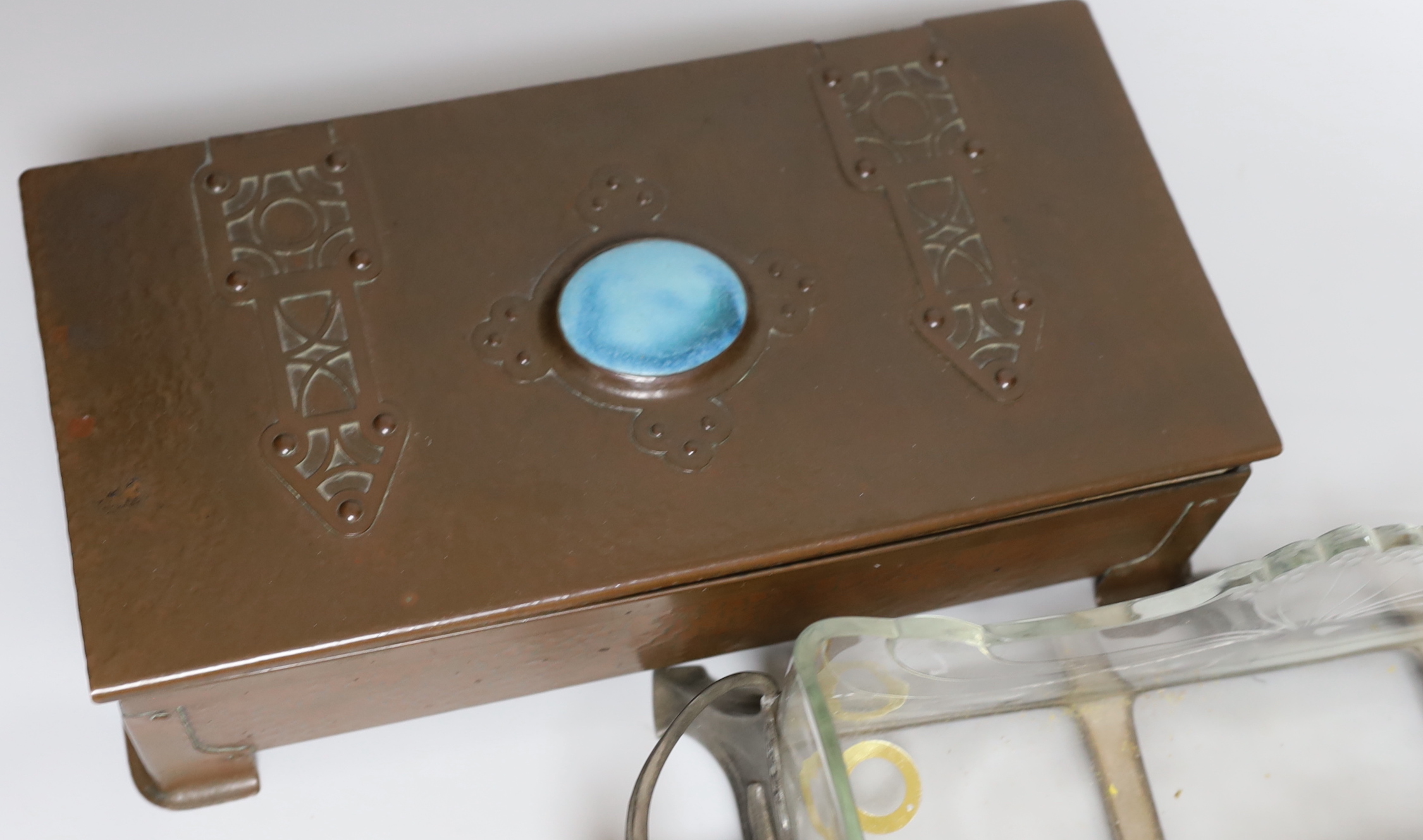An Arts and Crafts copper box, the lid inset with a Ruskin porcelain plaque and an Art Nouveau pewter mounted glass centrepiece dish, 41 cm wide